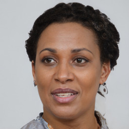 Joyful black adult female with short  brown hair and brown eyes