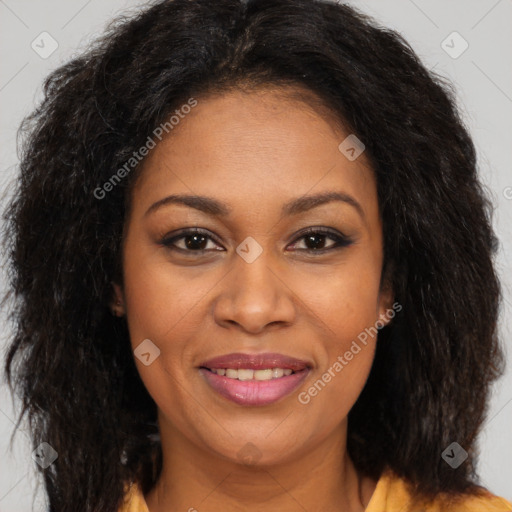 Joyful black young-adult female with long  brown hair and brown eyes