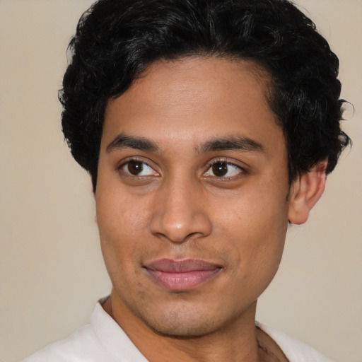 Joyful latino young-adult male with short  brown hair and brown eyes