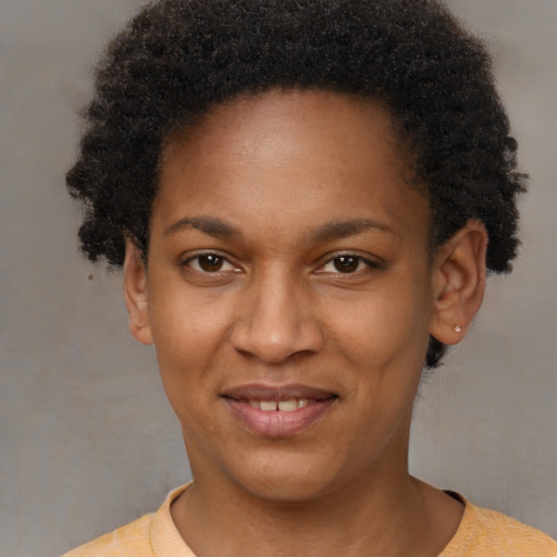 Joyful black young-adult female with short  brown hair and brown eyes