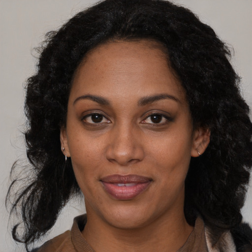 Joyful black adult female with medium  black hair and brown eyes