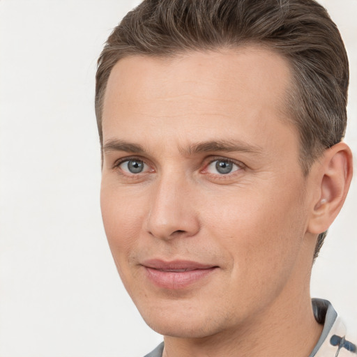 Joyful white young-adult male with short  brown hair and brown eyes