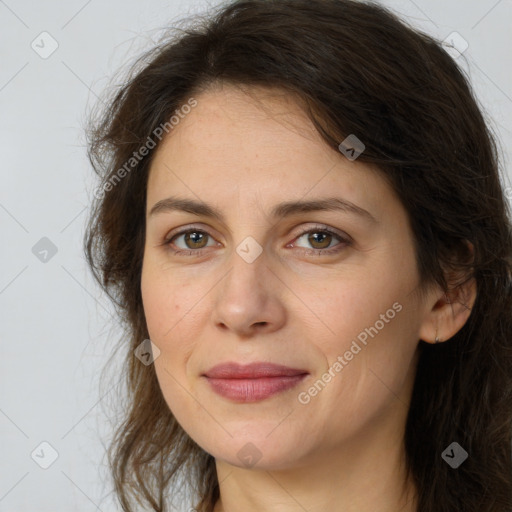 Joyful white adult female with long  brown hair and brown eyes