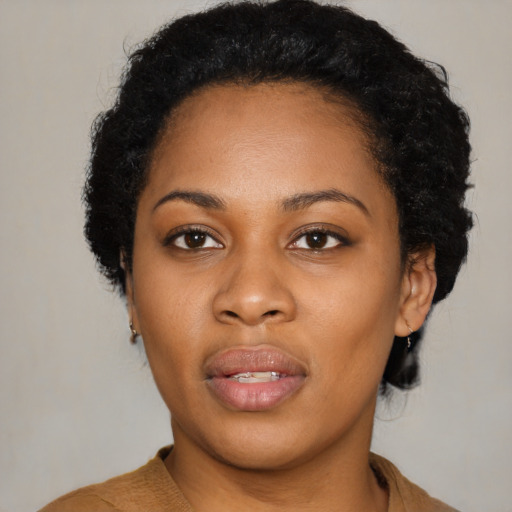 Joyful black young-adult female with short  black hair and brown eyes