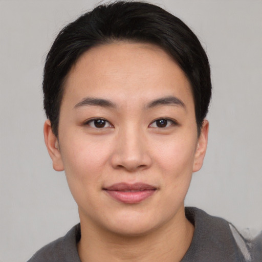 Joyful asian young-adult female with short  black hair and brown eyes