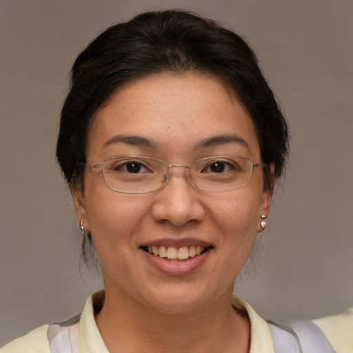 Joyful asian adult female with short  brown hair and brown eyes