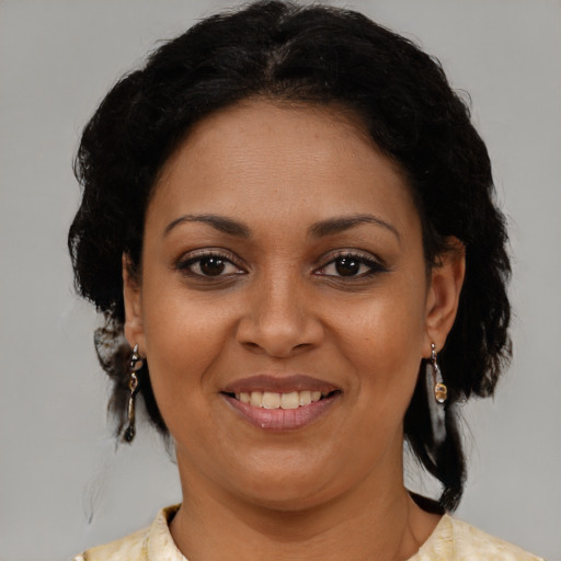 Joyful latino young-adult female with medium  brown hair and brown eyes