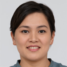 Joyful asian young-adult female with short  brown hair and brown eyes