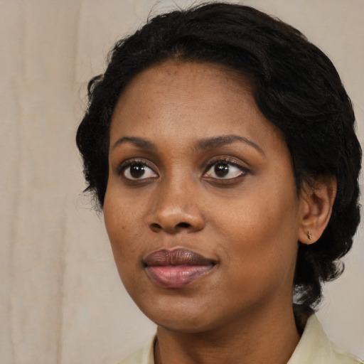 Joyful black young-adult female with medium  black hair and brown eyes