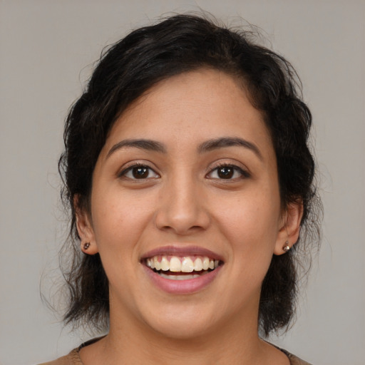 Joyful latino young-adult female with medium  brown hair and brown eyes