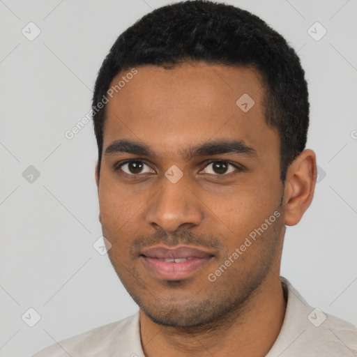 Joyful black young-adult male with short  black hair and brown eyes