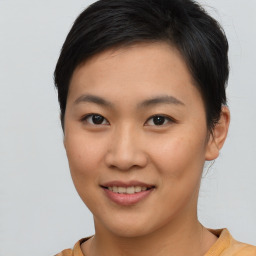 Joyful asian young-adult female with short  brown hair and brown eyes