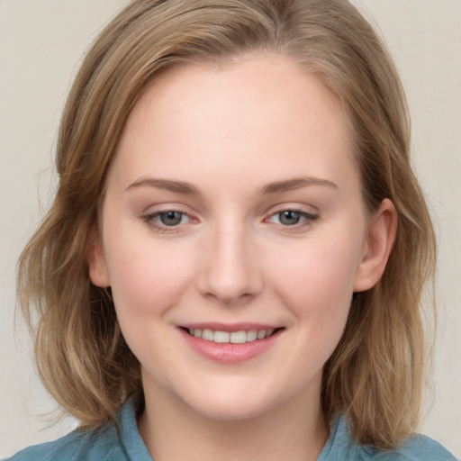 Joyful white young-adult female with medium  brown hair and blue eyes