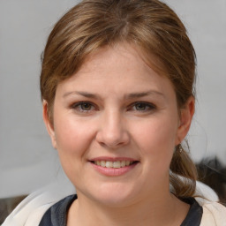 Joyful white young-adult female with medium  brown hair and brown eyes