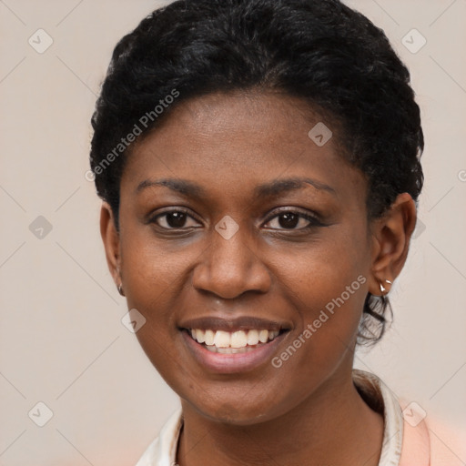 Joyful black young-adult female with short  black hair and brown eyes