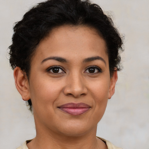 Joyful latino young-adult female with short  brown hair and brown eyes