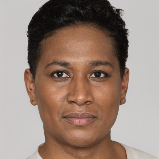 Joyful black young-adult female with short  brown hair and brown eyes