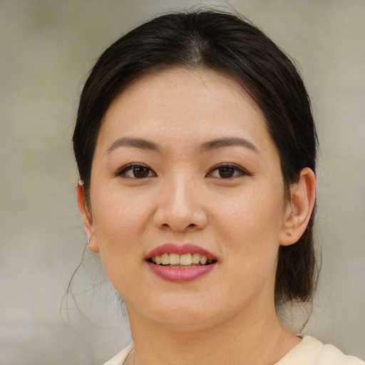 Joyful asian young-adult female with medium  brown hair and brown eyes