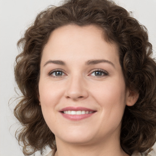 Joyful white young-adult female with medium  brown hair and green eyes