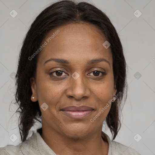 Joyful black adult female with medium  brown hair and brown eyes