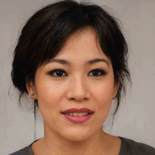 Joyful asian young-adult female with medium  black hair and brown eyes