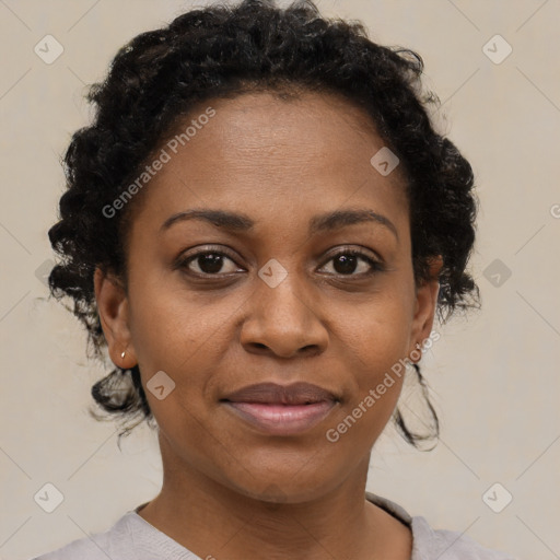 Joyful black adult female with short  brown hair and brown eyes