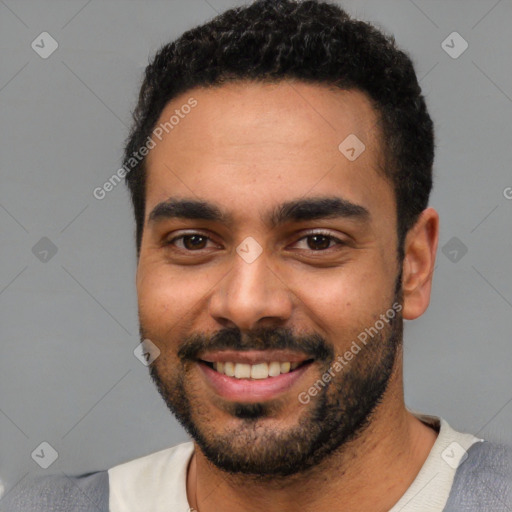 Joyful latino young-adult male with short  black hair and brown eyes