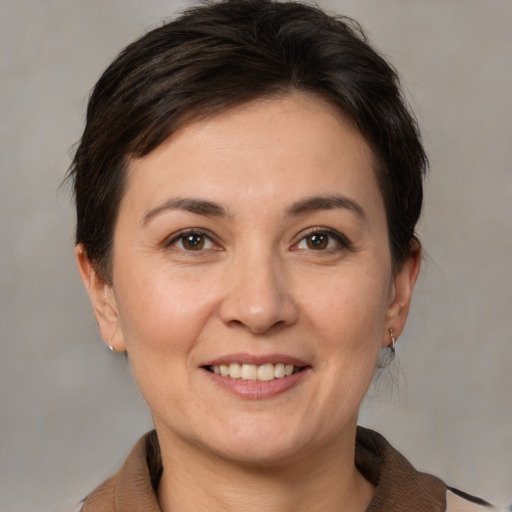 Joyful white adult female with medium  brown hair and brown eyes