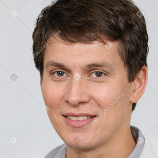 Joyful white adult male with short  brown hair and brown eyes