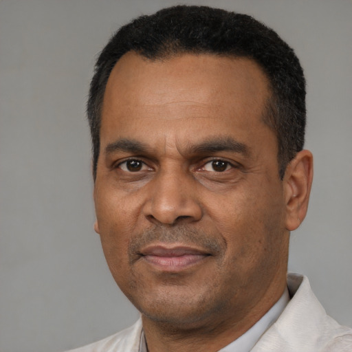 Joyful latino adult male with short  black hair and brown eyes