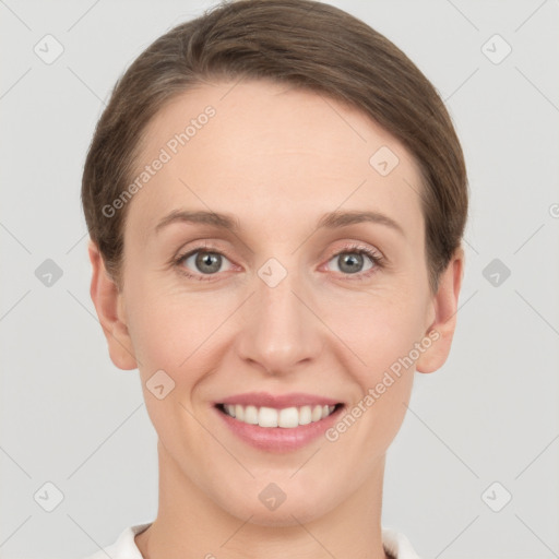 Joyful white young-adult female with short  brown hair and grey eyes