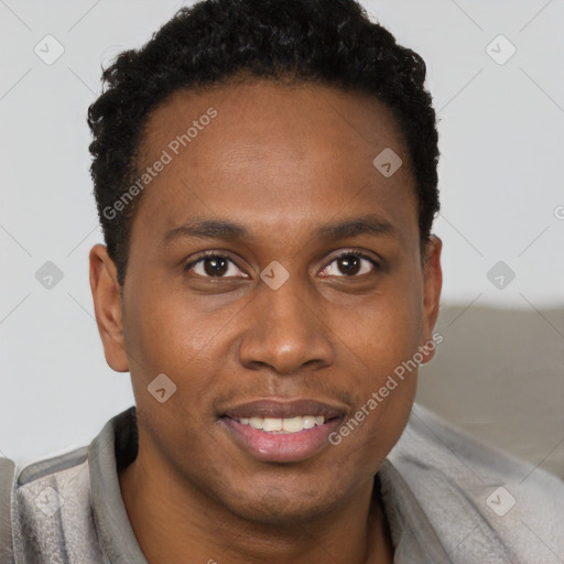 Joyful black young-adult male with short  brown hair and brown eyes