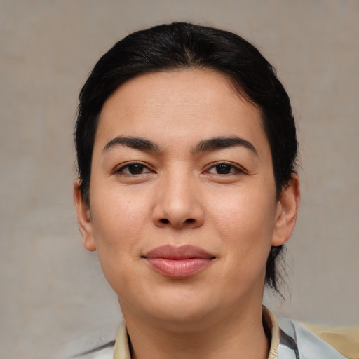 Joyful asian young-adult female with short  brown hair and brown eyes