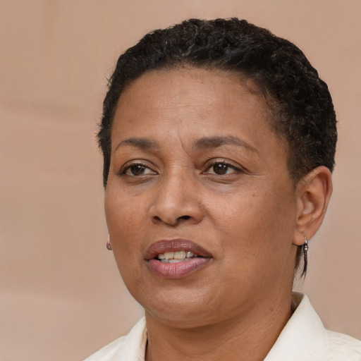 Joyful black adult female with short  brown hair and brown eyes