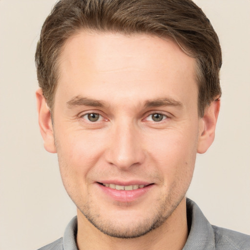 Joyful white adult male with short  brown hair and grey eyes