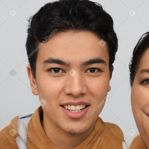 Joyful asian young-adult male with short  brown hair and brown eyes