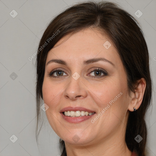 Joyful white adult female with medium  brown hair and brown eyes