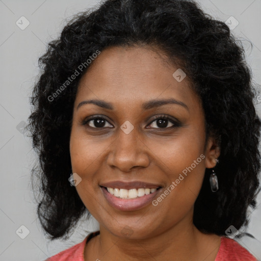 Joyful black young-adult female with long  brown hair and brown eyes