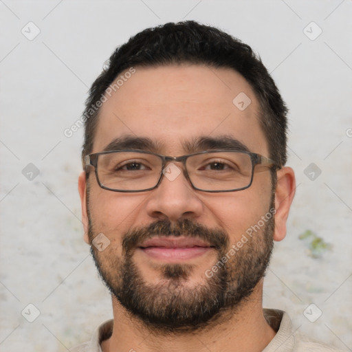 Joyful white young-adult male with short  black hair and brown eyes