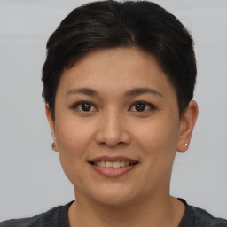 Joyful asian young-adult female with short  brown hair and brown eyes