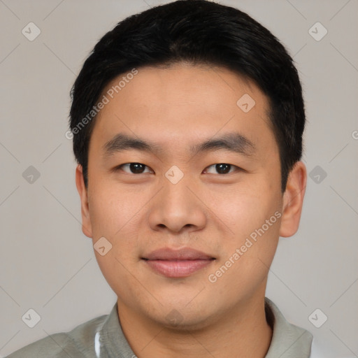 Joyful asian young-adult male with short  black hair and brown eyes