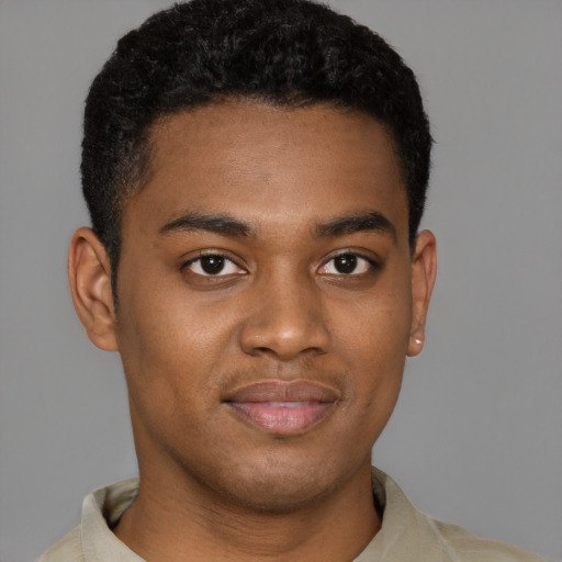 Joyful black young-adult male with short  brown hair and brown eyes
