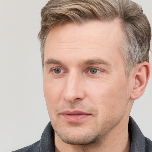 Joyful white adult male with short  brown hair and grey eyes