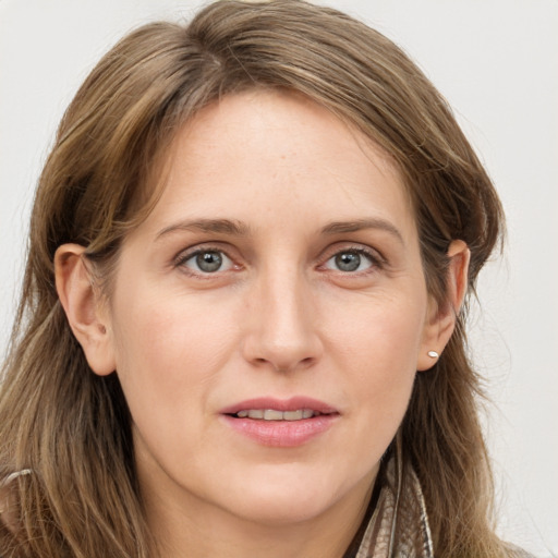 Joyful white young-adult female with long  brown hair and grey eyes