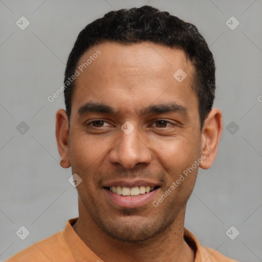 Joyful latino young-adult male with short  black hair and brown eyes