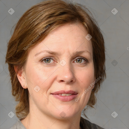 Joyful white adult female with medium  brown hair and blue eyes