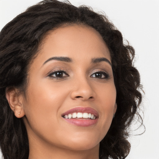 Joyful latino young-adult female with long  brown hair and brown eyes