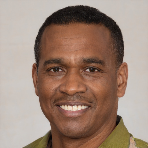 Joyful latino adult male with short  black hair and brown eyes