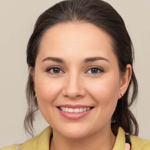 Joyful white young-adult female with medium  brown hair and brown eyes