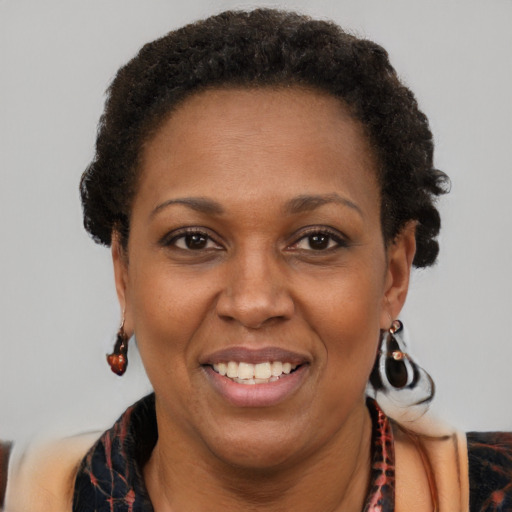 Joyful black adult female with short  brown hair and brown eyes